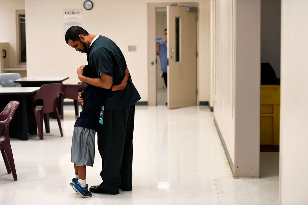 A 6-year-old boy hugs his father, an inmate at a correctional center in Burlington, Colorado, June 2016. (Getty/Joe Amon/The Denver Post)