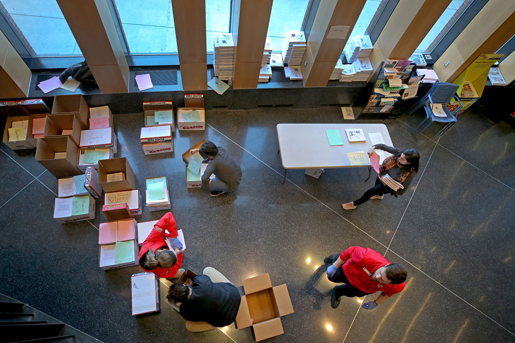 Volunteers and teachers in Boston deliver homework to students as schools shut down amid the COVID-19 outbreak, March 2020. (Getty/The Boston Globe/David L. Ryan)