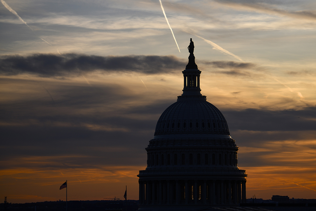 Streaks in the sky form at sunset behind the U.S. Capitol Building on November 13, 2019, in Washington, D.C. (Getty/Mark Makela)