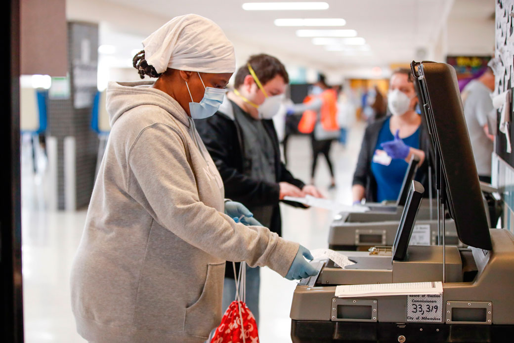 A woman casts her ballot in a presidential primary election in Milwaukee on April 7, 2020. (Getty/AFP/Kamil Krzaczynski)