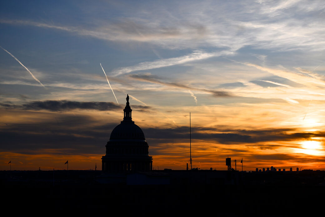 Streaks in the sky form at sunset behind the U.S. Capitol, November 2019. (Getty/Mark Makela)