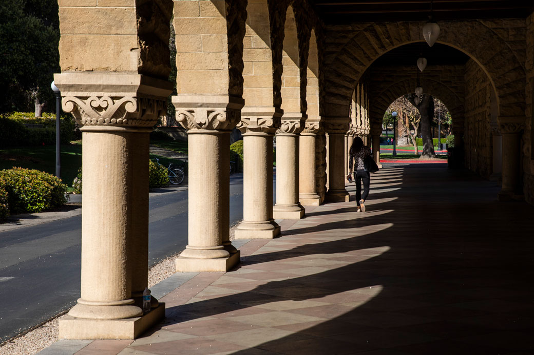 A person walks past archways during a quiet morning at Stanford University on March 9, 2020, in Stanford, California. (Getty/Philip Pacheco)