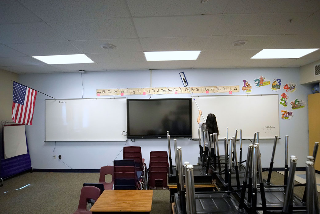 A worker cleans the walls in a classroom at a school in Provo, Utah, on May 18, 2020. (Getty/George Frey)