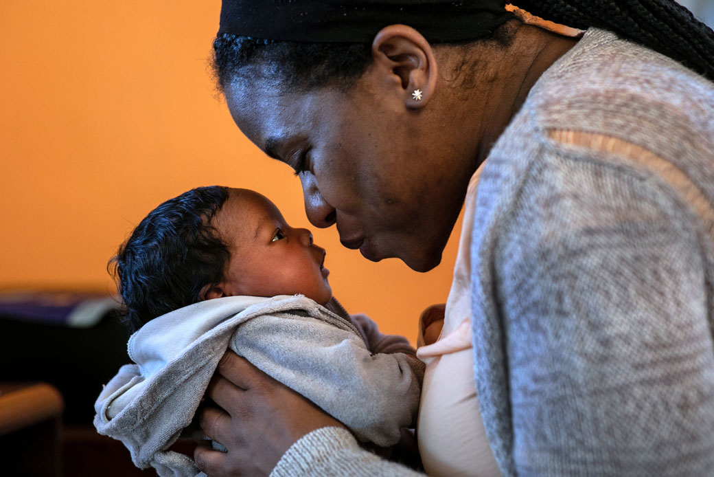 A woman holds her newborn son in Mount Vernon, New York, March 2020. (A woman holds her newborn son in Mount Vernon, New York, March 2020.)