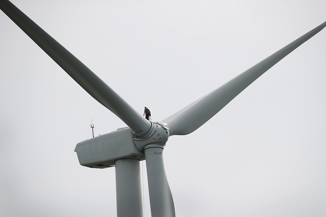 A worker repairs a power-generating windmill on June 14, 2018, near Dwight, Illinois. (Getty/Scott Olson)