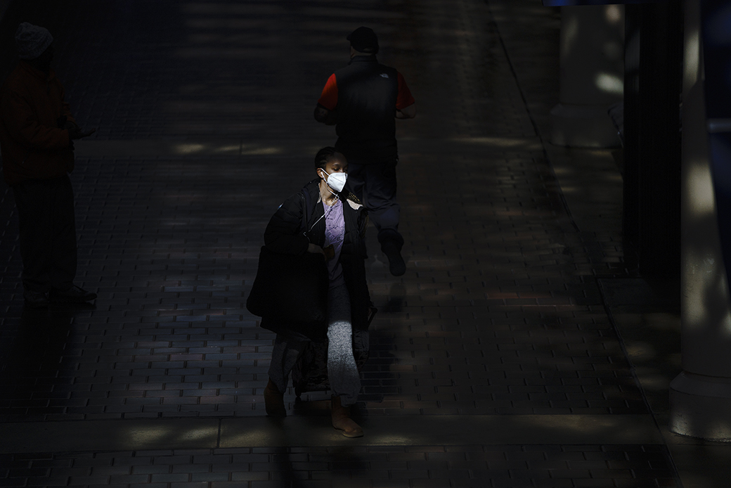 A woman wearing a face mask walks through a nearly empty Union Station during morning rush hour on April 3, 2020, in Washington, D.C. (Getty/Drew Angerer)
