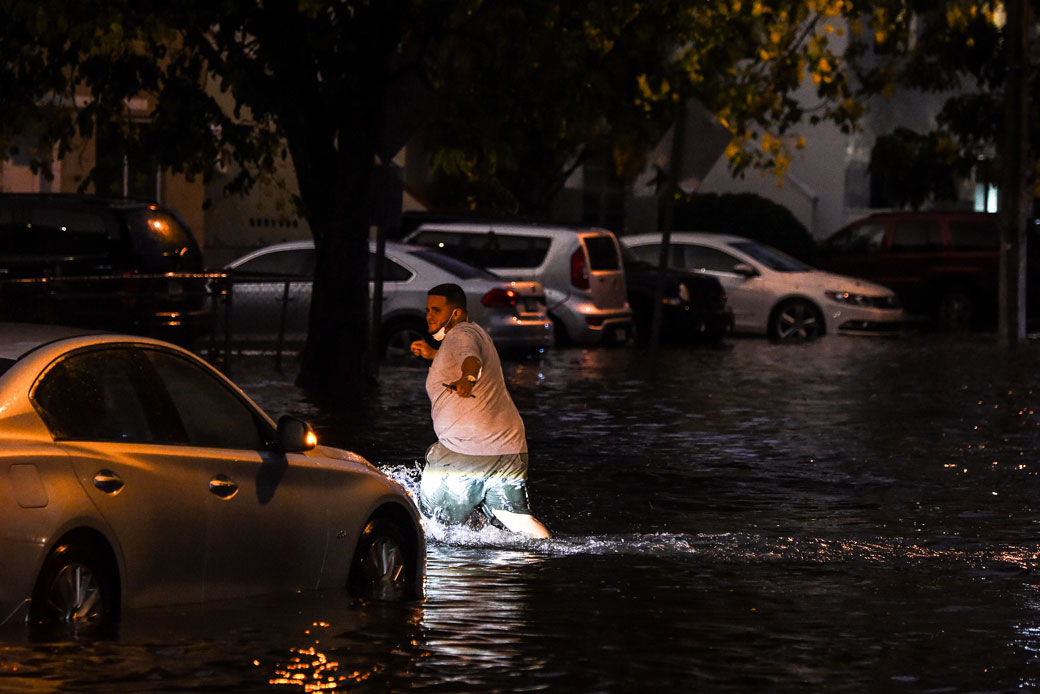 A man walks through floodwaters during heavy rainfall in Miami on May 26, 2020. (Getty/AFP/Chandan Khanna)