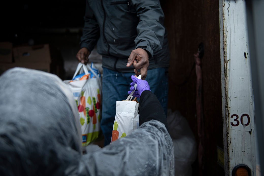 Volunteers unload food to hand out to those in need, included people affected by the coronavirus pandemic, in District Heights, Maryland, April 2020. (Getty/Brendan Smialowski/AFP)