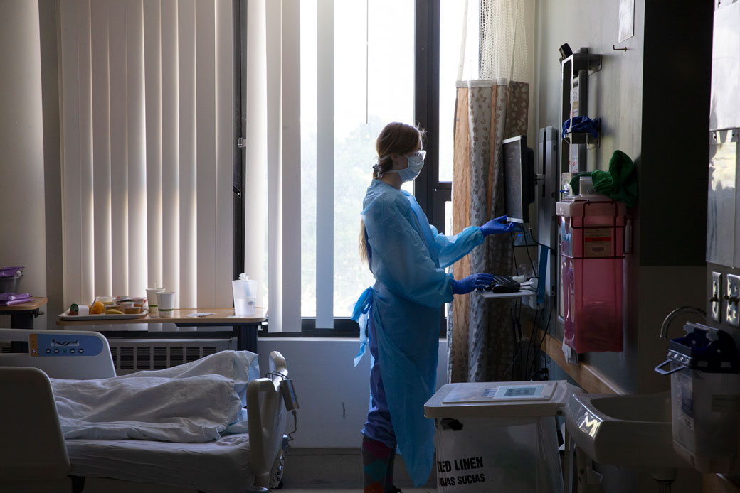 A nurse administers care to a patient in the acute care COVID-19 unit at a medical center in Seattle, May 2020. (Getty/Karen Ducey)