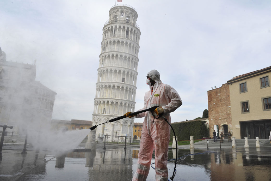 A worker carries out sanitation operations in a deserted Piazza dei Miracoli in Pisa, Italy, on March 17, 2020. (Getty/Laura Lezza)