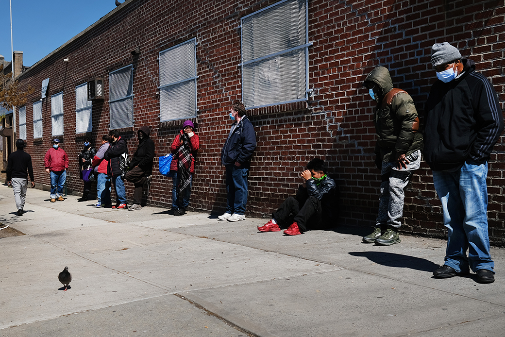 People wait in line to receive food at a food bank on April 28, 2020, in the Brooklyn borough of New York City. (Getty/Spencer Platt)