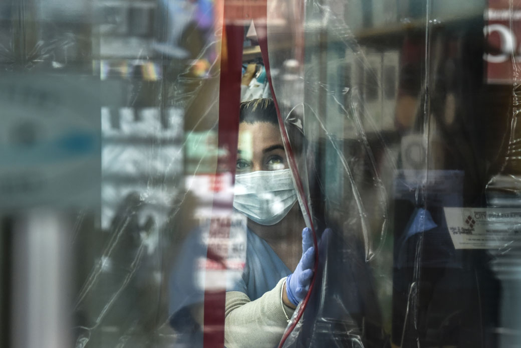 A pharmacist wearing personal protective equipment works in the Elmhurst neighborhood of New York City in April 2020. (Getty/Stephanie Keith)