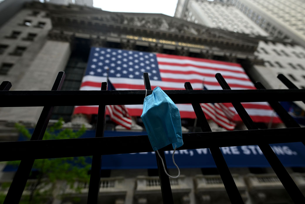 A face mask hangs on a fence in New York City, May 2020. (Getty/AFP/Johannes Eisele)