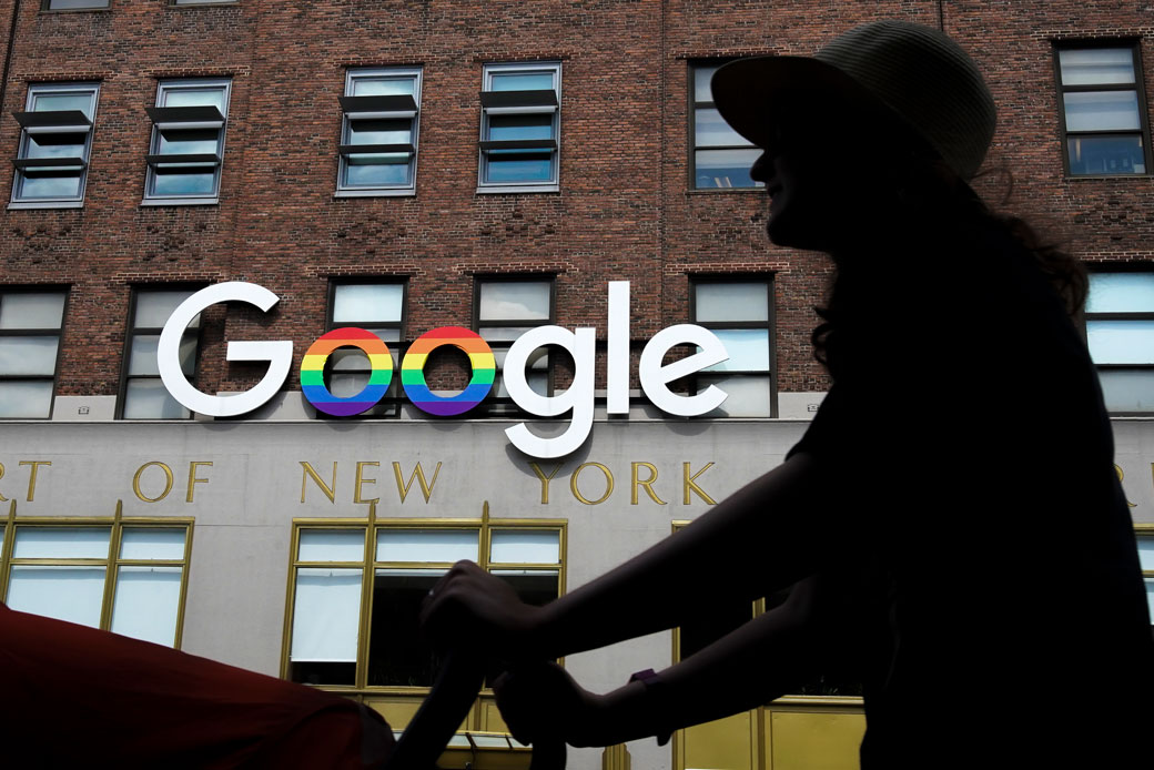 A woman walks past Google's New York City office in June 2019. (Getty/Drew Angerer)