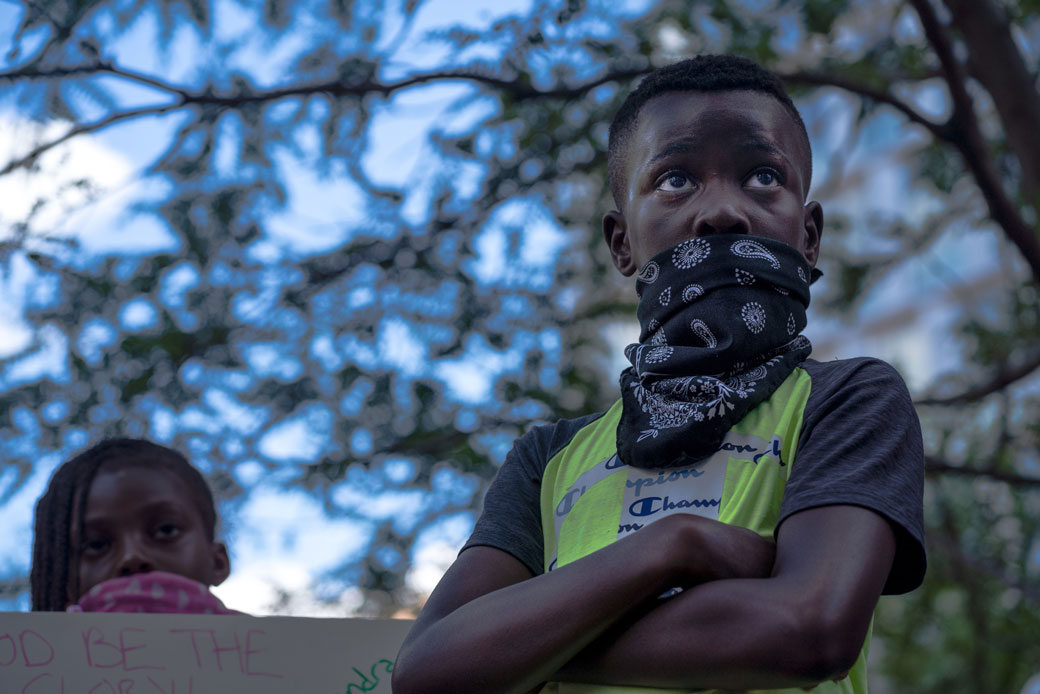 A young protester listens during a Justice for George Floyd demonstration on June 11, 2020, in Minneapolis. (Getty/Kerem Yucel/AFP)