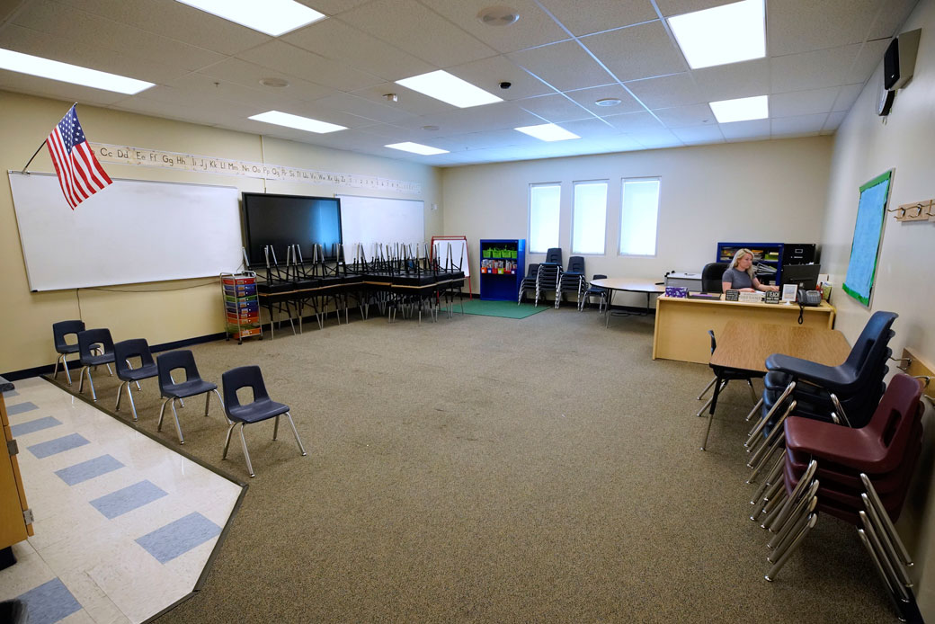 A teacher works at her desk in an empty classroom in Provo, Utah, May 2020. (Getty/George Frey)