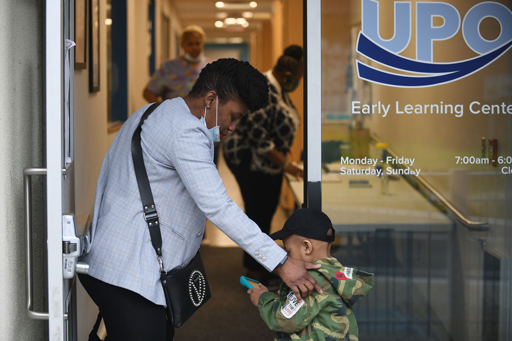 A mother drops her 3-year-old son off at an emergency child care facility in Washington, D.C., April 15, 2020. (Getty/Astrid Riecken)