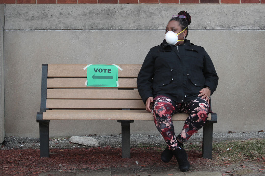 A woman rests after voting, April 2020. (Getty/Scott Olson)