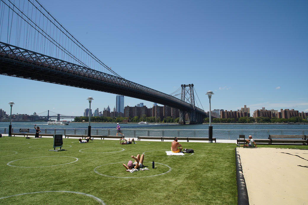 People lay out on the grass while maintaining social-distancing guidelines in Williamsburg, Brooklyn, on August 3, 2020. (Getty/Rob Kim)