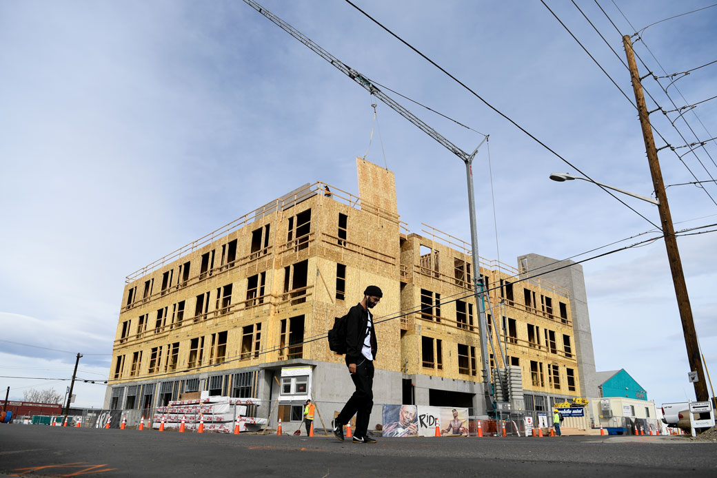  (A man walks in front of a construction site in Denver on February 8, 2018.)