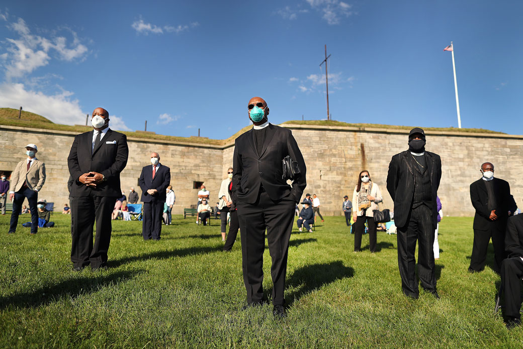  (Black clergy members stand with other attendees during a Mass for racial healing on Castle Island in South Boston on June 13, 2020.)