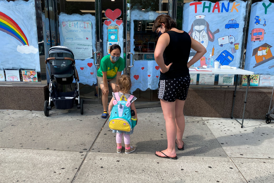  (Children are dropped off at a day care in Queens, New York, during phase four of the city's reopening following the coronavirus pandemic, July 2020.)