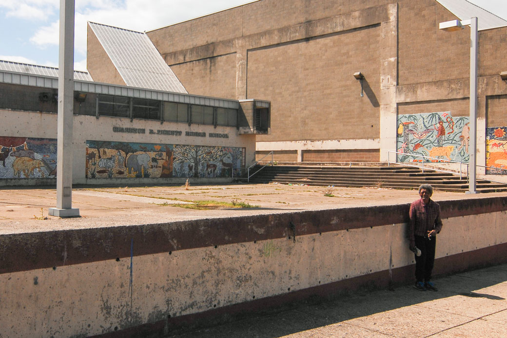 A person stands alone in front of a closed middle school in Philadelphia on April 14, 2020.