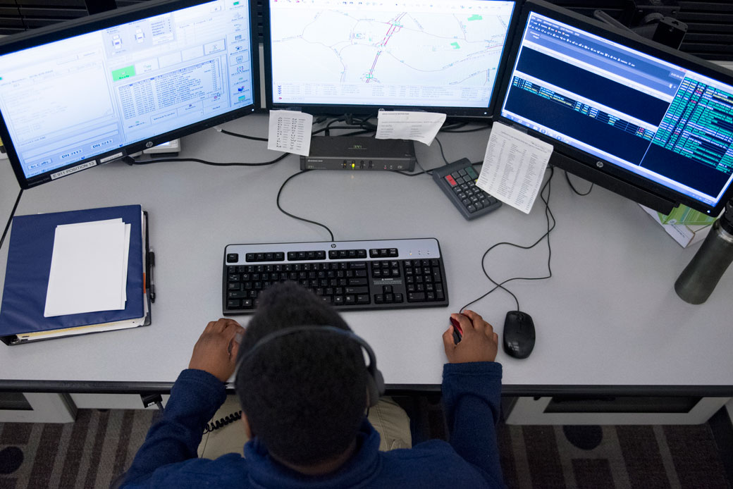 An employee answers calls at the Essex County Regional Communications Center in Middleton, Massachusetts, on June 22, 2017. (Getty/The Boston Globe/Nicholas Pfosi)