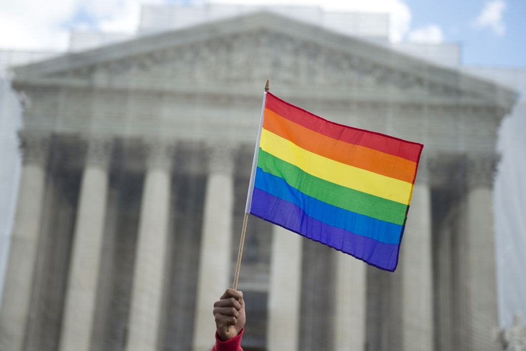 A pride flag is waved in front of the U.S. Supreme Court on March 26, 2013, in Washington, D.C. (Getty/AFP/Saul Loeb)