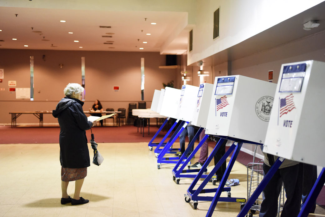 A voter walks to fill in her ballot at a polling station in New York, November 2018. (Getty/Xinhua/Han Fang)