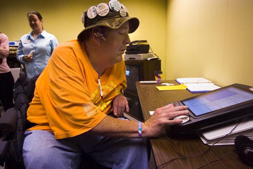 Mike McCarty tests an electronic voting machine that allows disabled voters to cast their ballots in privacy at the Center for People With Disabilities. (Getty/Marty Caivano)