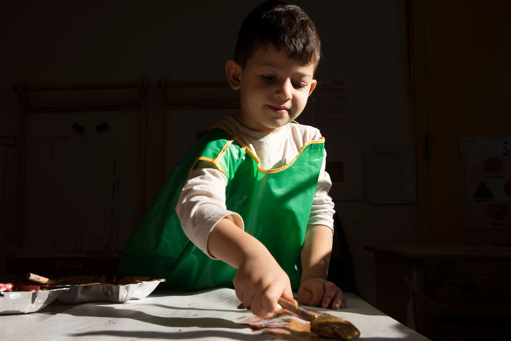  (A 4-year-old paints autumn leaves in a child care center in Arnold, Maryland, on November, 25, 2019.)