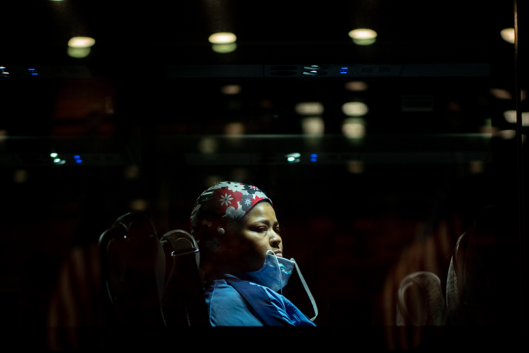 A nurse sits in a bus after her shift at a hospital on April 14, 2020, in New York City. (Getty/David Dee Delgado)