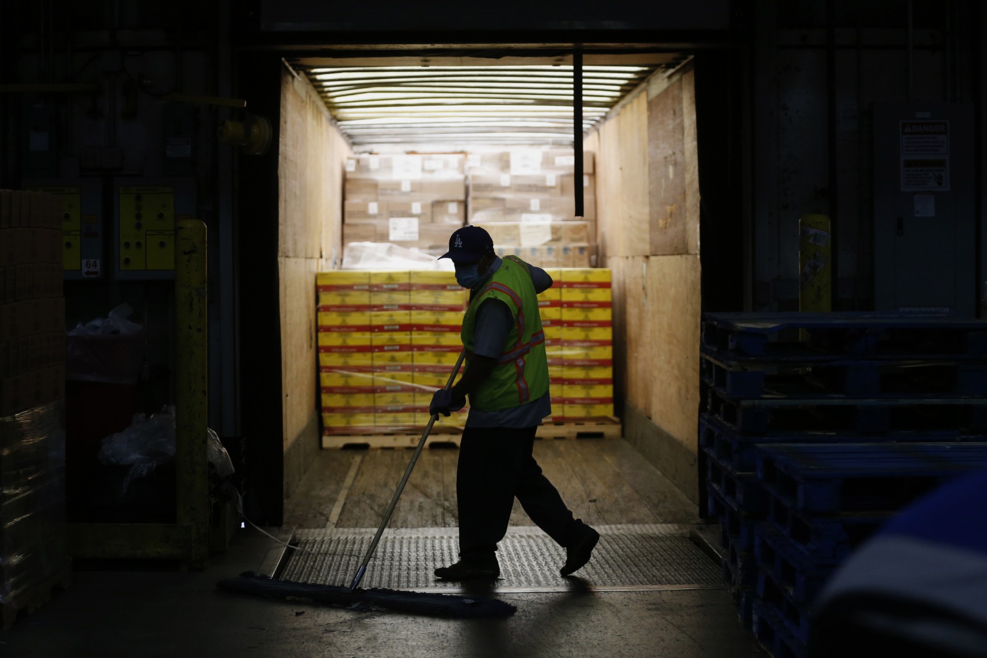 RIVERSIDE, CA -- APRIL 28: Associates fill orders for both Ralphs and Food 4 Less grocery stores at the Ralphs Distribution Center on Tuesday, April 28, 2020, in Riverside, CA. The 80 acre, 1.2 million square feet, full service distribution center employing 1100 workers took on more product after automated warehouses couldn't keep up with the spike in demand after restaurants were shuttered. (Gary Coronado / Los Angeles Times via Getty Images)