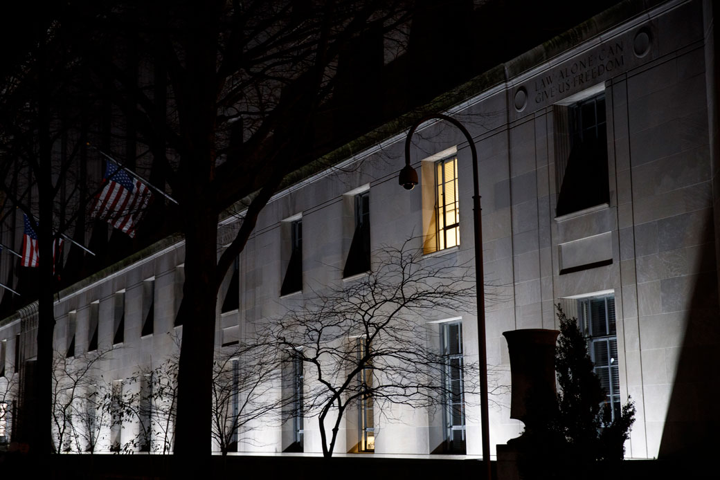 The U.S. Department of Justice building is seen on a March 2019 evening with one light on, Washington, D.C. (Getty/Drew Angerer)