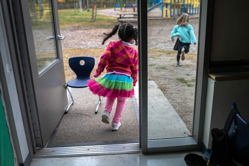 Children race outside during a 