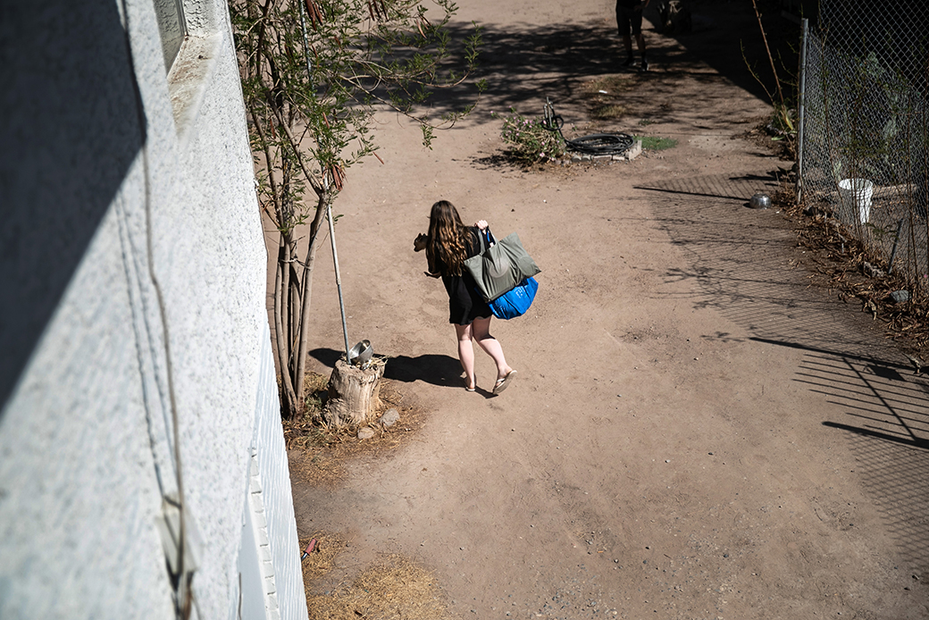 A child carries a pet from her apartment as her family is evicted for nonpayment of rent, September 2020, in Phoenix. (Getty/John Moore)