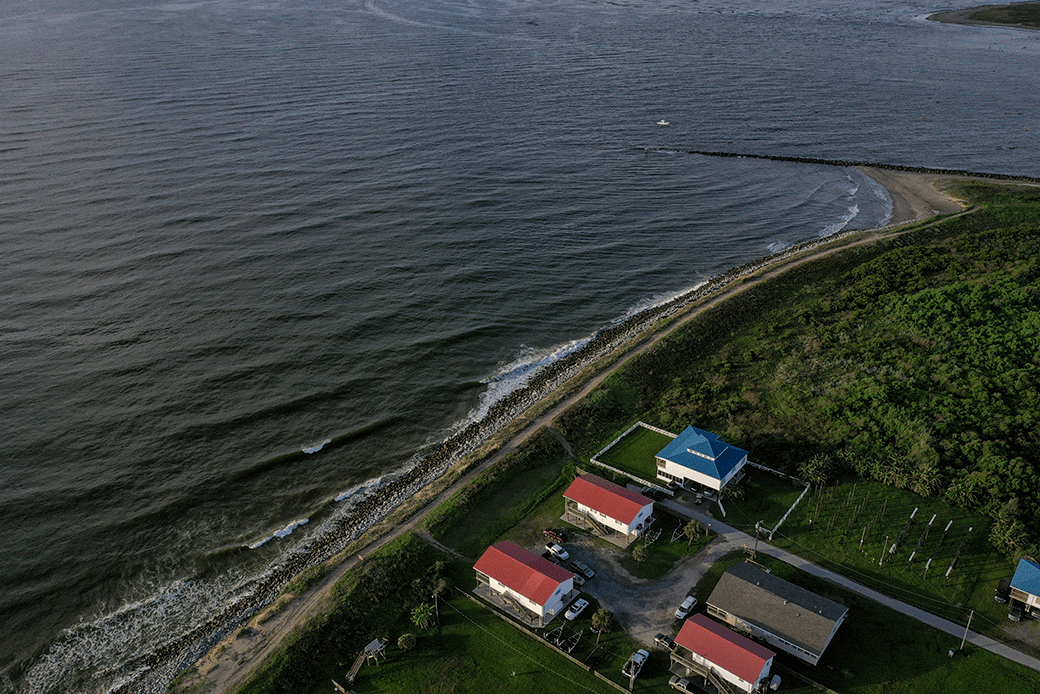 Homes sit next to the Gulf of Mexico in Grand Isle, the only inhabited barrier Island in Louisiana, which is threatened by a combination of sea level rise and sinking land due to climate change, August 2019. (Getty/Drew Angerer)