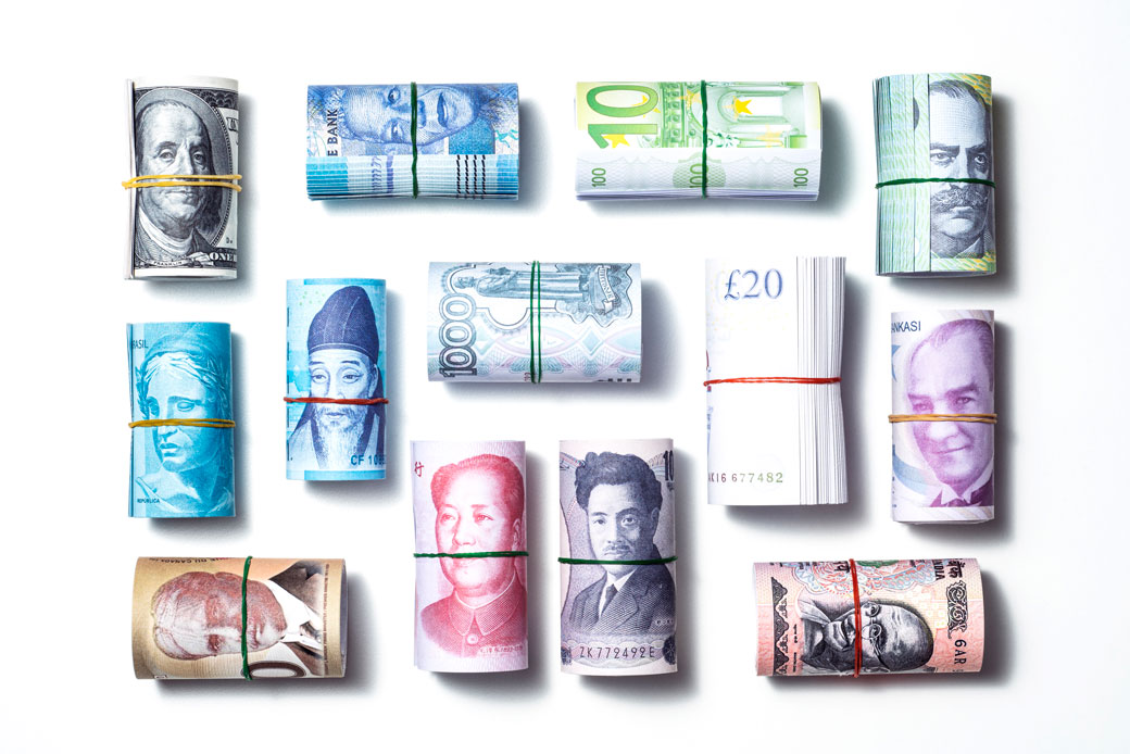 Money rolls are displayed on a white background. (Tarik Kizilkaya)