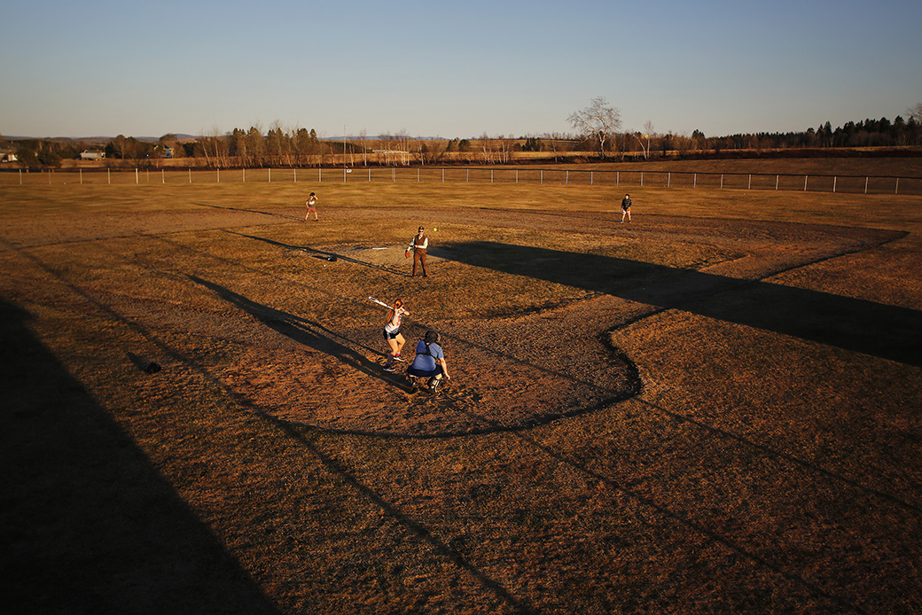 A teacher plays softball with a group of students, May 2019. (Getty/Derek Davis/Portland Press Herald)