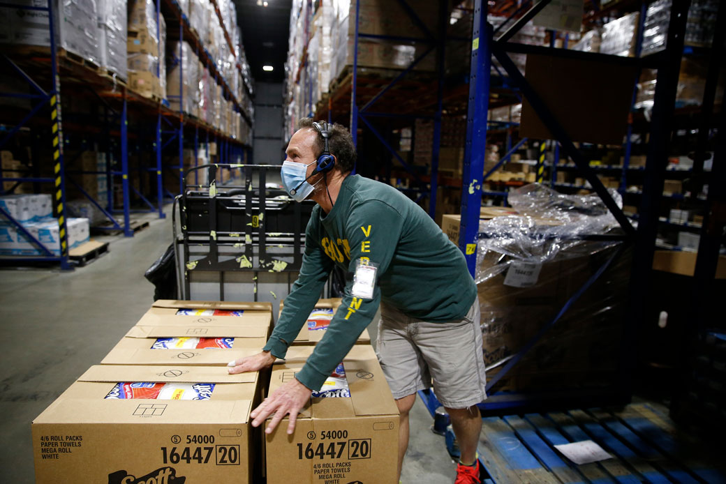  (An employee loads up paper towels at Associated Grocers of New England Inc. in Pembroke, New Hampshire, on October 14, 2020.)