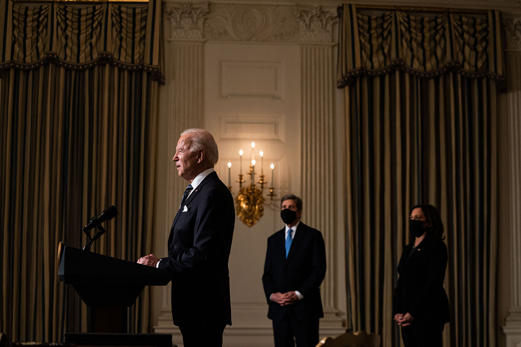 President Joe Biden speaks about climate change issues in the State Dining Room of the White House on January 27, 2021, in Washington. Biden signed several executive orders related to the climate change crisis that day. Also pictured, left to right, are Special Presidential Envoy for Climate John Kerry and Vice President Kamala Harris. (Getty/Anna Moneymaker-Pool)