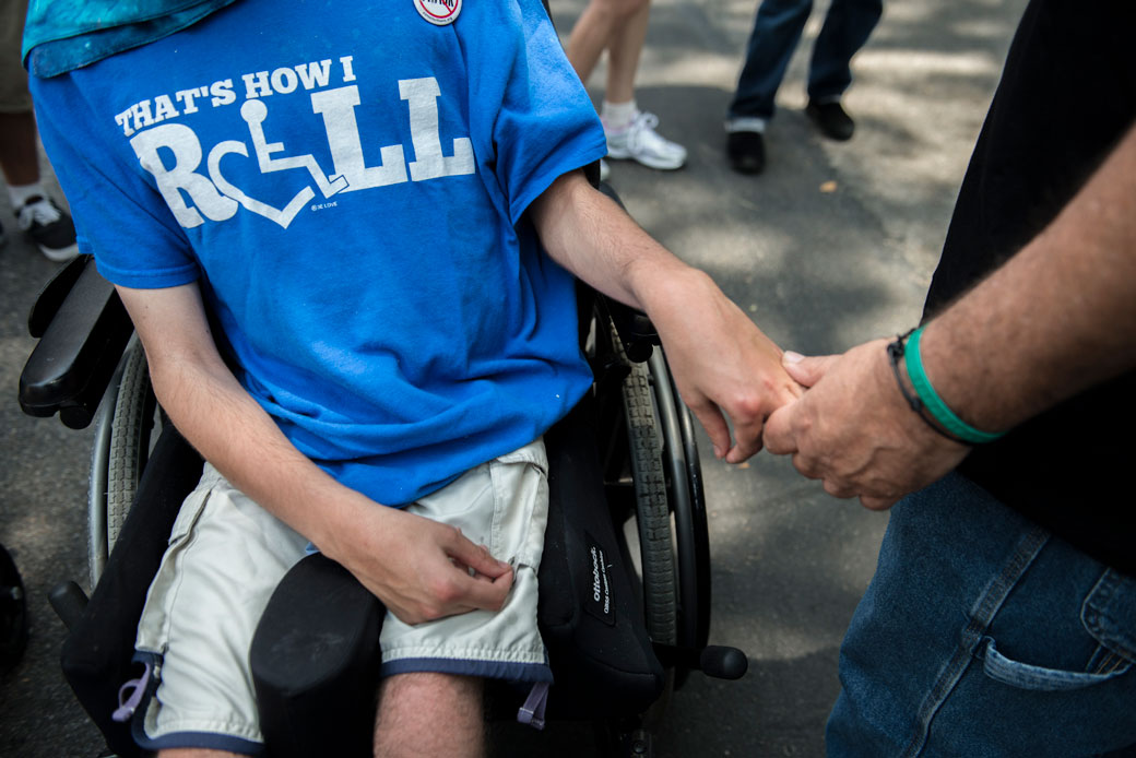 A father holds his son's hand during the first annual Disability Pride Parade in New York City on July 12, 2015. (Getty/Stephanie Keith)