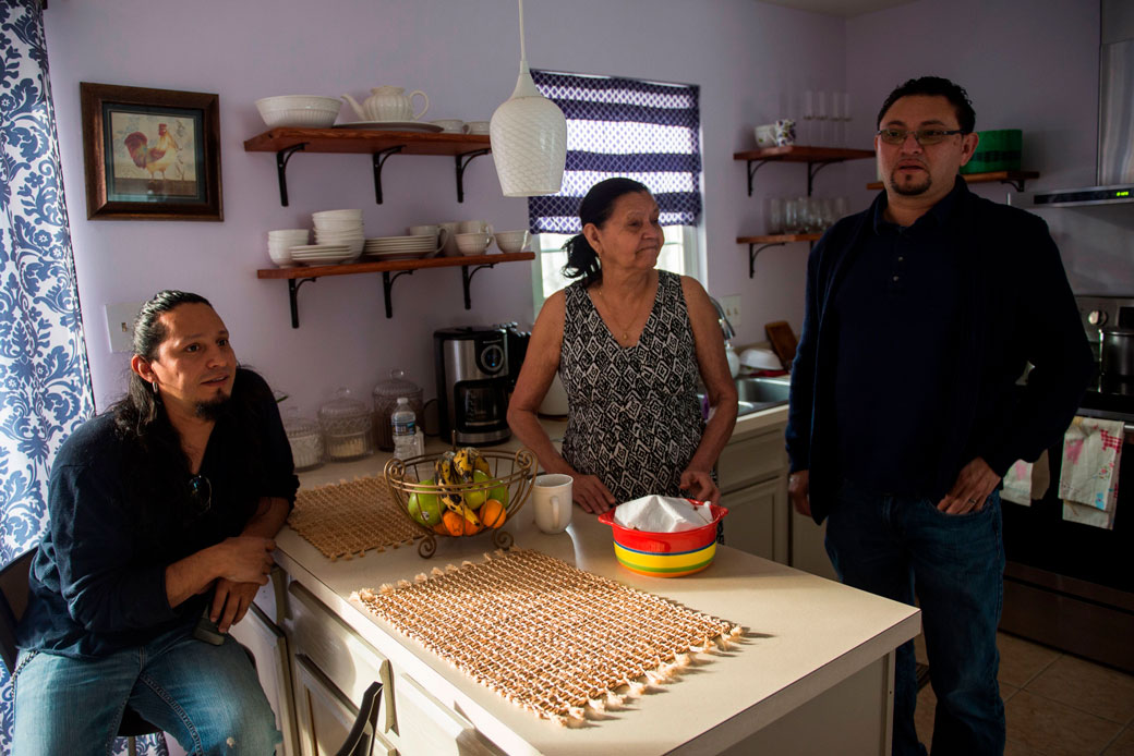 A Salvadoran immigrant affected by the U.S. government's end of TPS in January 2018 rests with his family at their kitchen in Laurel, Maryland, in January 2018. (Getty/Andrew Caballero-Reynolds)