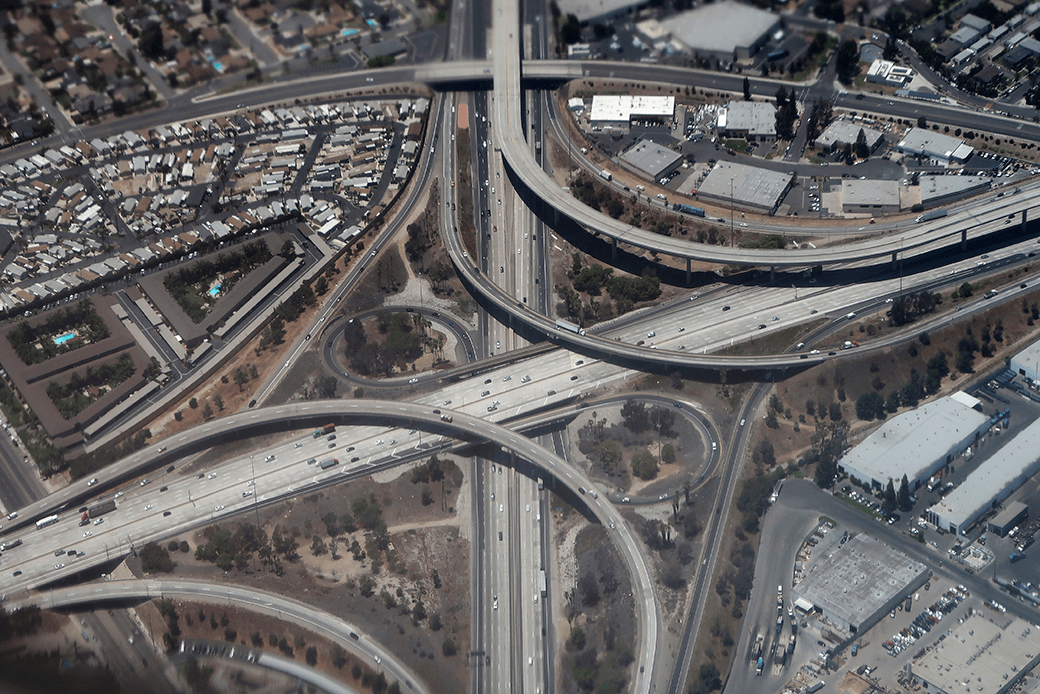 A highway interchange is seen through the exhaust of an airplane in Costa Mesa, California, June 2018. (Getty/Gary Hershorn)