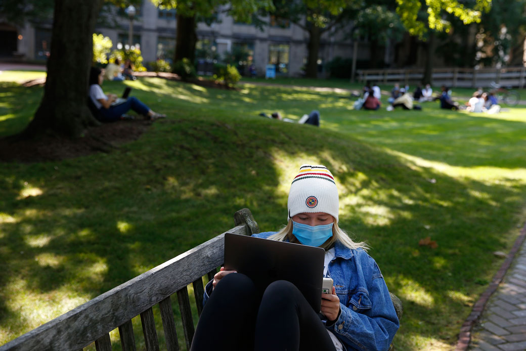 A student wears a mask to protect against the spread of COVID-19 as she works on her laptop at a college campus in Boston on September 23, 2020. (Getty/The Boston Globe/Jessica Rinaldi)
