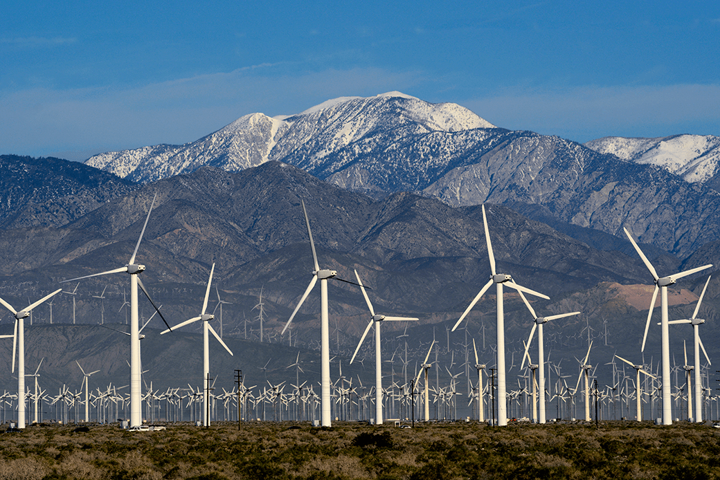 Wind turbines generate electricity near Palm Springs, California, with snow-covered Mt. San Jacinto in the background, February 2019. (Getty/Robert Alexander)