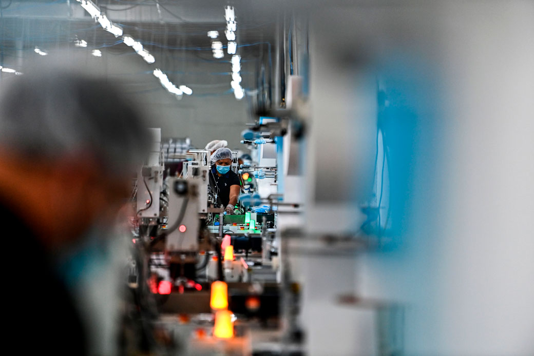  (Employees make respiratory masks in a family-owned medical equipment factory in north Miami on February 15, 2021.)