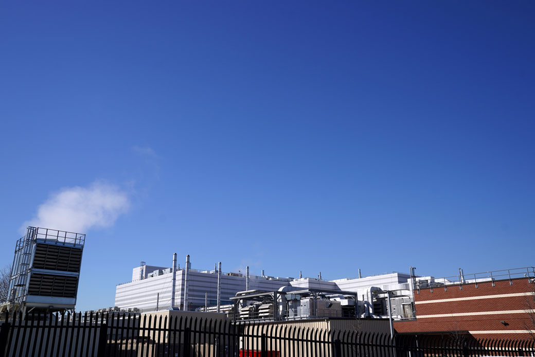  (A manufacturing facility in Baltimore is seen through a security fence, February 2021.)