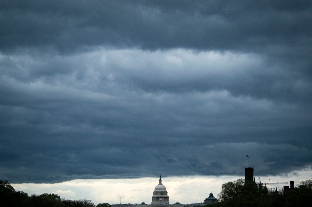 Clouds form above the U.S. Capitol in between rain showers on the National Mall, March 2021. (Getty/Al Drago)